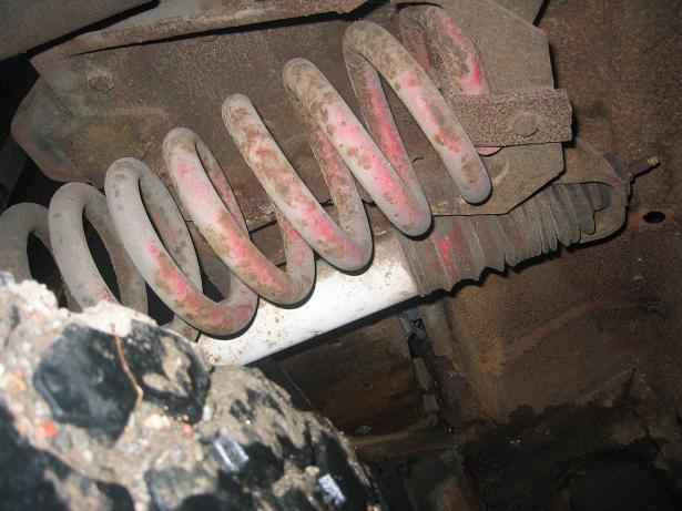 Front axle suspension spring with red paint markings