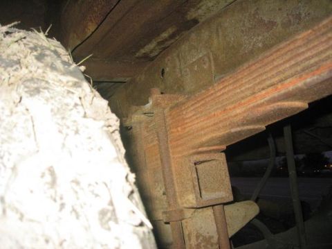 1986 Ford Bronco - Rusty leaf spring and frame components visible in the undercarriage of a vehicle.