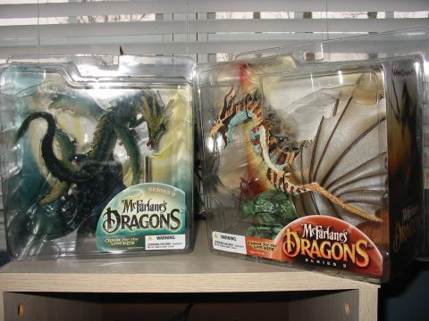 1991 Ford Bronco - McFarlane's Dragons Series 2 and Series 3 action figures are displayed in their original packaging on a shelf.