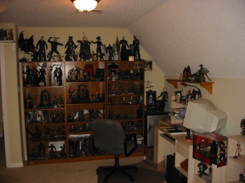 1991 Ford Bronco - A room displays a large collection of action figures and memorabilia on shelves, alongside a desk and computer.