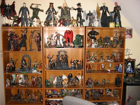 1991 Ford Bronco - A large collection of action figures and collectibles fills multiple shelves in a room.