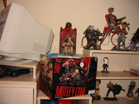 1991 Ford Bronco - A toy drum set Motley Crue is displayed on a shelf next to a vintage computer monitor and action figures.