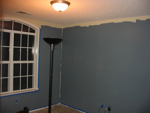 1991 Ford Bronco - A room is being painted, with tape protecting the window and floor from the dark gray paint.