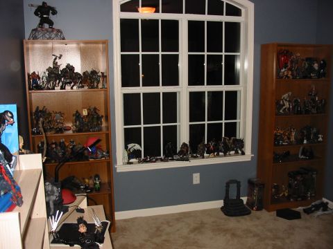 1991 Ford Bronco - Room interior with multiple display cases filled with various action figures and collectibles.