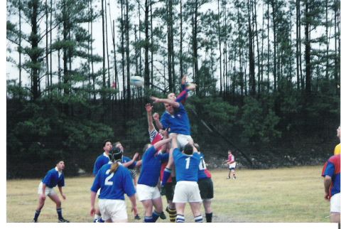 1992 Ford Bronco - A rugby game is in progress with players leaping to catch the ball in mid-air.