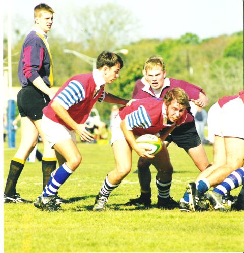 1992 Ford Bronco - A rugby match is in progress with players vying for the ball.