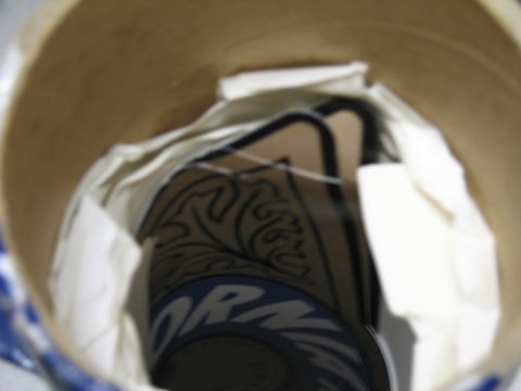 1991 Ford LTD Crown Victoria - Decals wrapped in tissue inside a cardboard tube, showing partial blue lettering and a black tribal-style graphic.