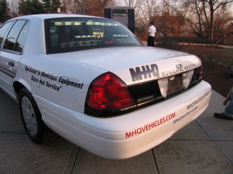 1991 Ford LTD Crown Victoria - Rear-quarter view of a white Crown Victoria lettered M-H-Q Municipal Equipment Sales and Service with MHQVEHICLES.COM on the bumper.