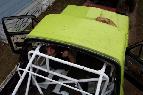 1978 Ford Bronco - Rollcage installation in progress inside a bright green truck cab.