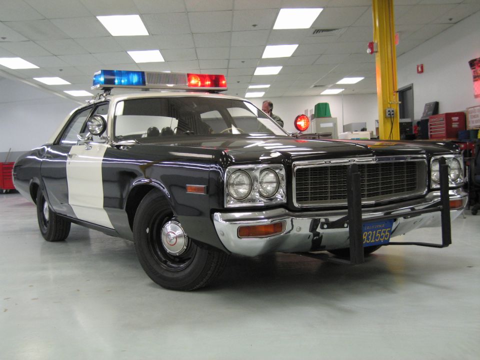 Black-and-white police cruiser, front three-quarter view with push bumper