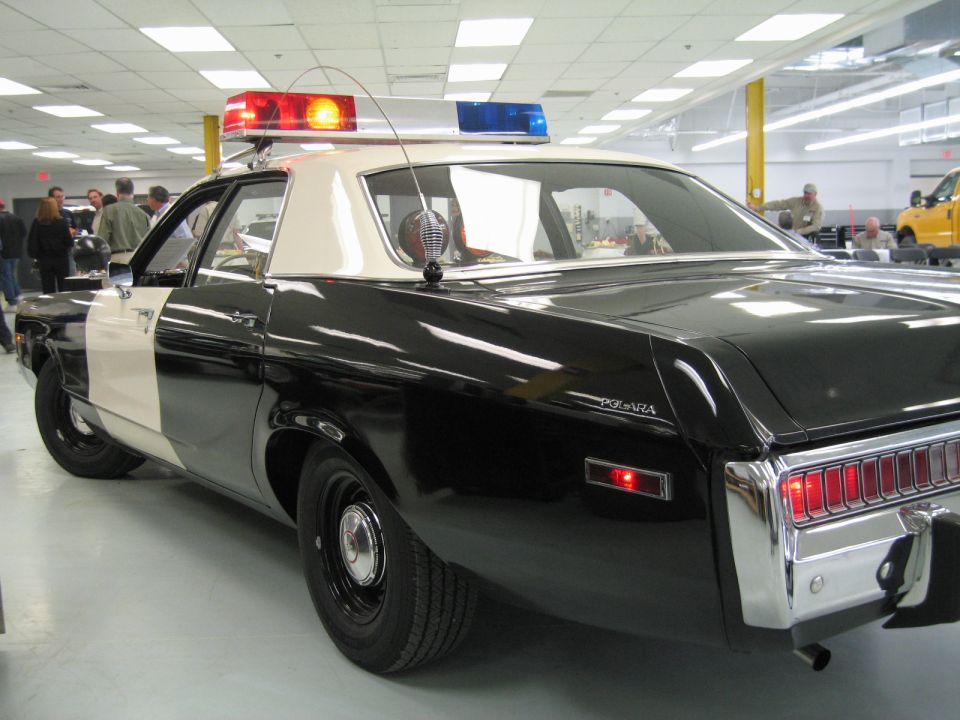 Rear three-quarter of black Dodge Polara police car with POLARA badge