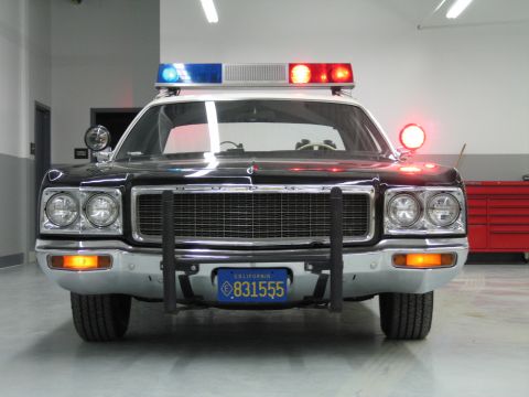 1991 Ford LTD Crown Victoria - head-on view of a black Dodge police car with DODGE lettering on the grille and California plate 831555.