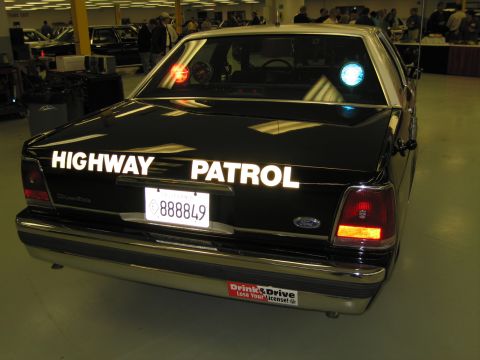 1991 Ford LTD Crown Victoria - Rear view of a black Ford LTD Crown Victoria CHP sedan with HIGHWAY PATROL lettering and California plate 888849.