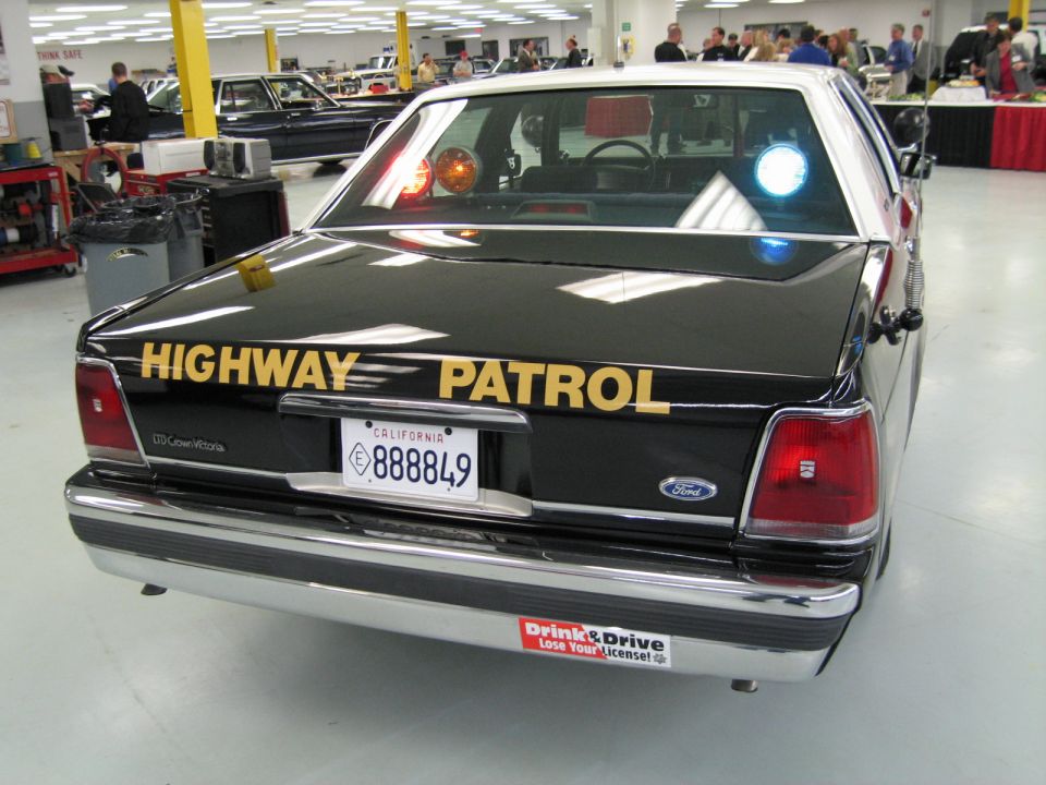 Rear view of a Ford Crown Victoria CHP sedan with gold HIGHWAY PATROL lettering, plate 888849