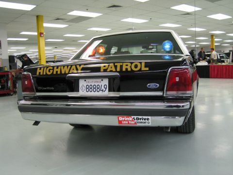 1991 Ford LTD Crown Victoria - Low-angle rear view of a Ford LTD Crown Victoria CHP sedan with HIGHWAY PATROL lettering and California plate 888849.