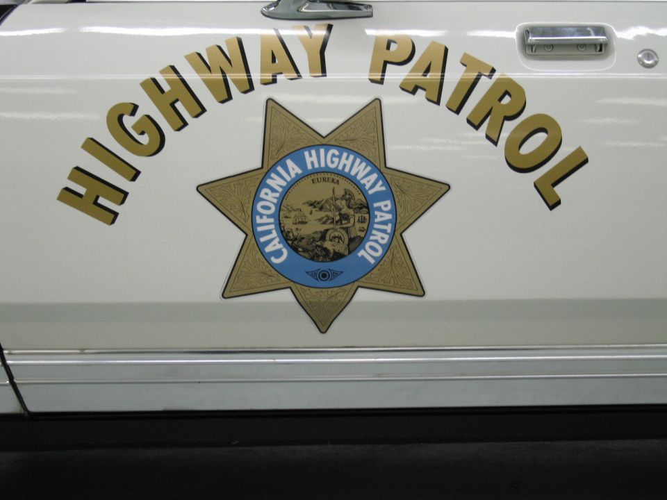Close-up of white CHP door panel with Highway Patrol text and star emblem