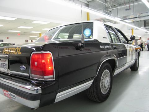 1991 Ford LTD Crown Victoria - Low rear three-quarter view of a black-and-white CHP Ford sedan with Safety and Service lettering and plate 888849.