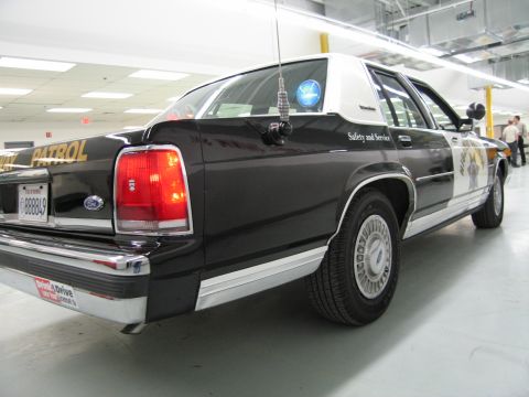 1991 Ford LTD Crown Victoria - Low rear three-quarter view of a black-and-white CHP Ford sedan with whip antenna, Safety and Service text, plate 888849.