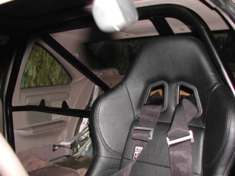 1993 Ford Thunderbird - Interior view shows a racing seat and roll cage. Harness has PRO 2000 text.