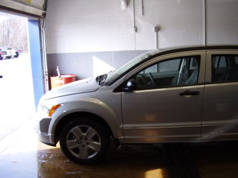 1997 Ford Taurus - Side view of a silver crossover SUV parked indoors.
