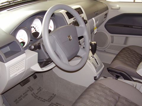 1997 Ford Taurus - The interior of a car is shown, the dashboard, steering wheel, and seats.