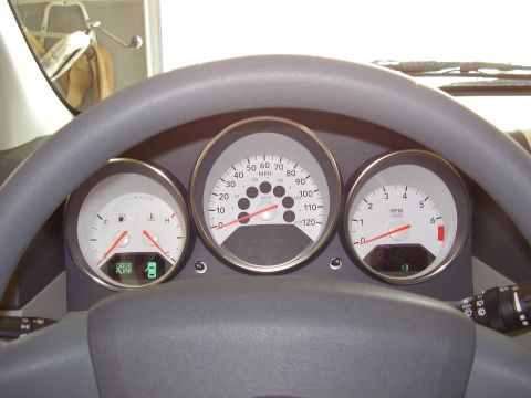 1997 Ford Taurus - The interior of a vehicle shows its dashboard gauges, including a speedometer and tachometer.