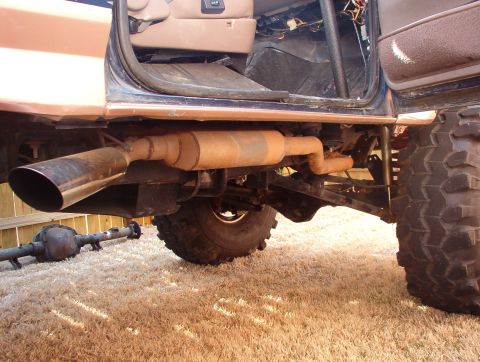 1994 Ford Bronco - The exhaust system and rear axle are visible, along with the interior of a 1994 Ford Bronco.