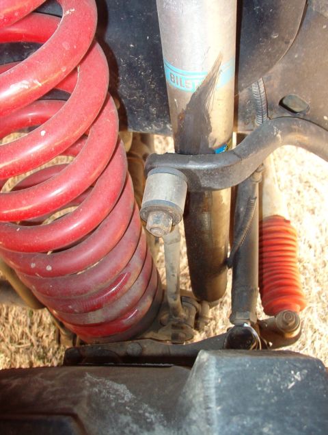 1994 Ford Bronco - The end links are cobbled together, and since they're not straight, they've shifted the sway bar sideways, and it's gouging into this shock.