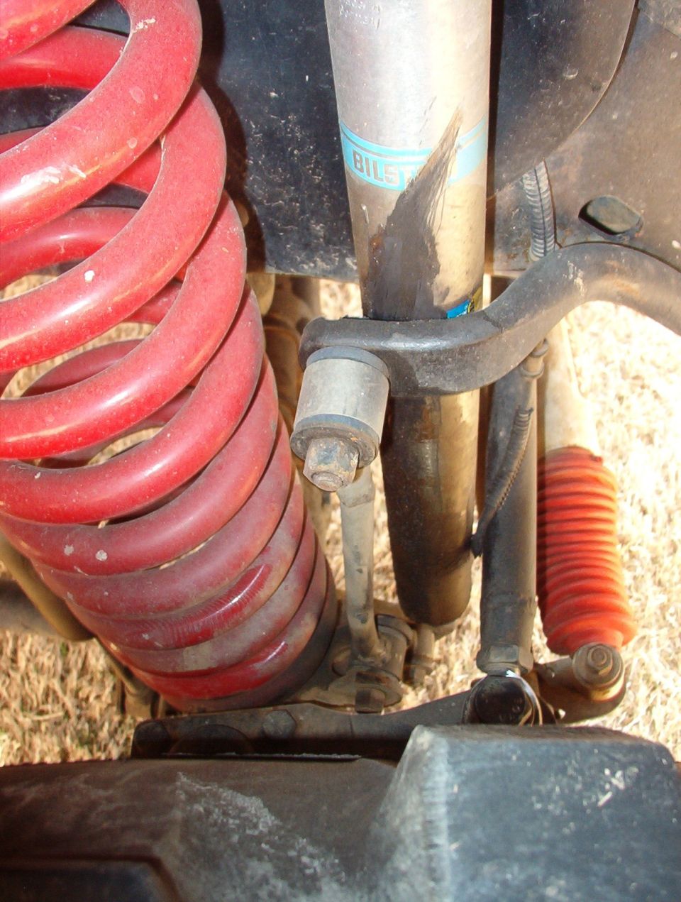 The end links are cobbled together, and since they're not straight, they've shifted the sway bar sideways, and it's gouging into this shock.