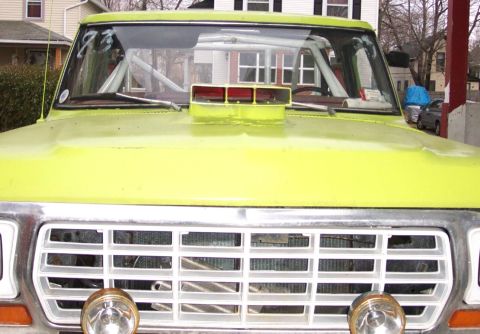 1978 Ford Bronco - Front view of a yellow 1978 Ford Bronco, modified with a rollcage and hood scoop.