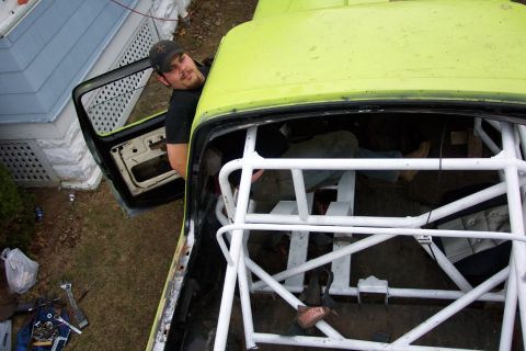 1978 Ford Bronco - Vehicle interior with a rollcage and a person visible through the open door.