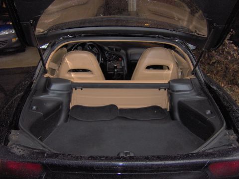 1993 Mazda RX-7 - The interior and open trunk of a black sports car are visible, tan seats and carpeting.
