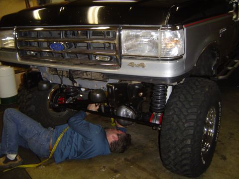 1989 Ford Bronco - Ratchet strapping the axle to the frame to get out of the garage