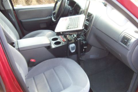 2005 Ford Explorer - Interior view of a 2005 Ford Explorer equipped with a laptop and radio system in the center console.