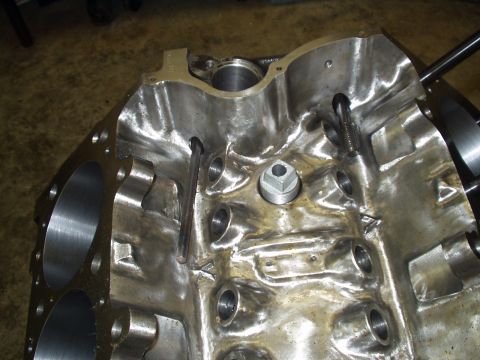 1990 Ford Mustang - The interior of a bare engine block shows machined surfaces and various threaded holes.