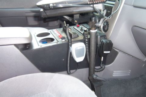 2005 Ford Explorer - The interior console of a police vehicle is equipped with communication devices and controls.