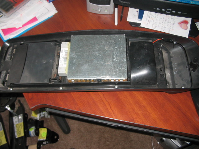 Dashboard trim piece with Ford-branded electronic module and wiring