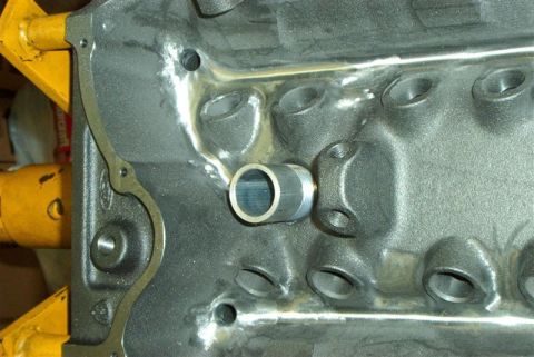 1990 Ford Mustang - Close-up of an engine block a metal tube fitting and the Supermotors.net watermark.