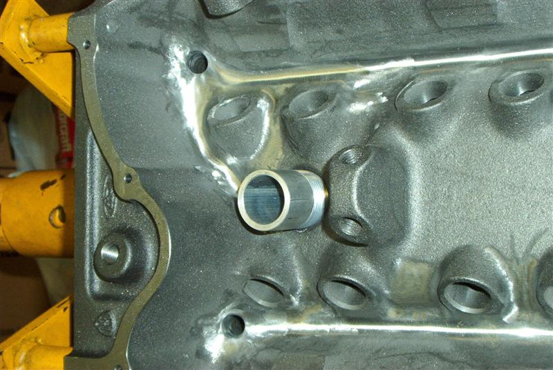 Engine block with metal tube fitting. Supermotors.net logo visible