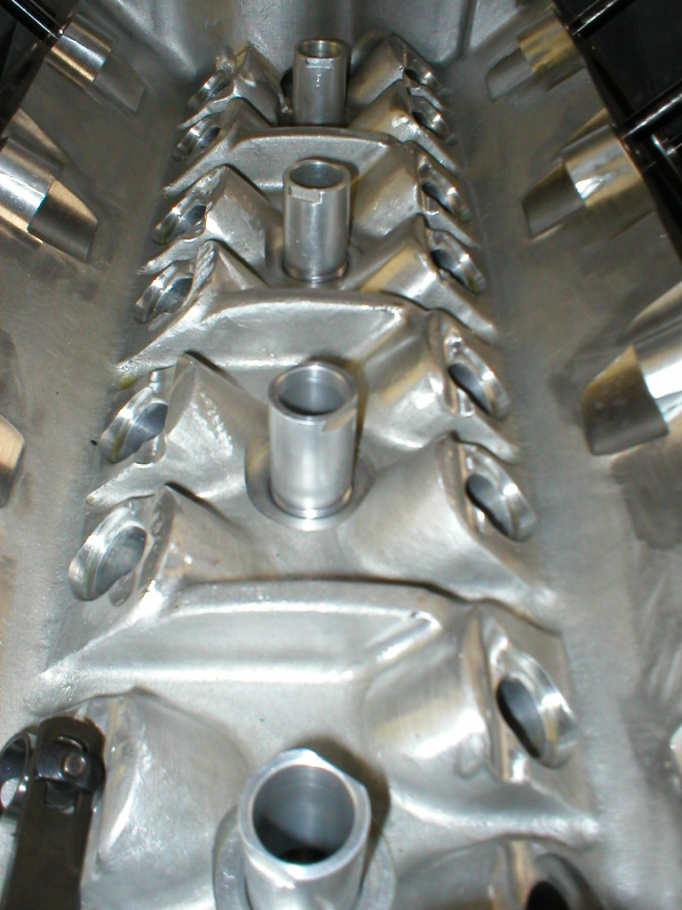 Close-up of an aluminum intake manifold with ports and raised bosses