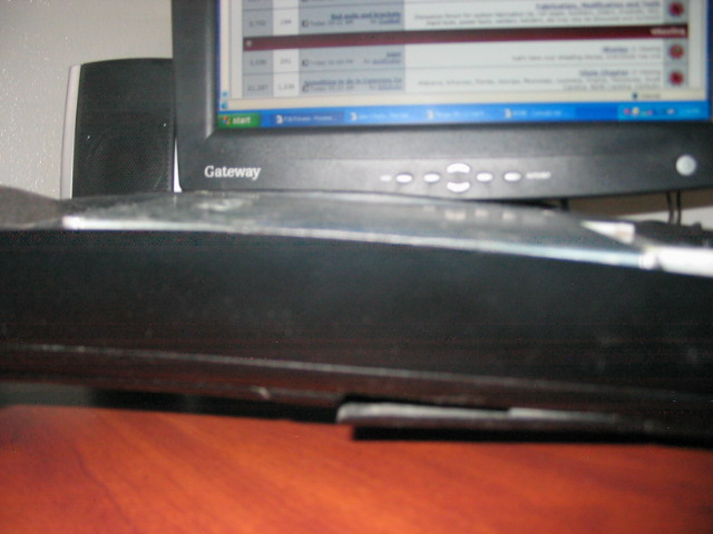 Gateway computer monitor with a speaker to the left, showing a spreadsheet on screen