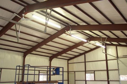 1986 Ford Ranger - The interior of a large metal building is shown, complete with industrial lighting and a scissor lift.