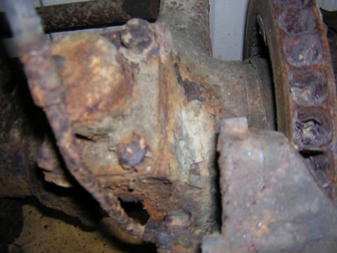 1979 Ford Bronco - This close-up shows significant rust and corrosion on a vehicle's axle housing and surrounding components.