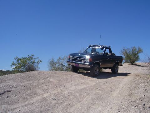 1991 Ford Bronco - This 1991 Ford Bronco is shown off-roading on a sunny day.