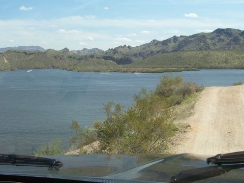 1991 Ford Bronco - Scenic view of a lake and mountains, taken from the dashboard of a vehicle.
