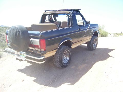 1991 Ford Bronco - This 1991 Ford Bronco is seen from the rear, a spare tire on the tailgate and a roof rack.