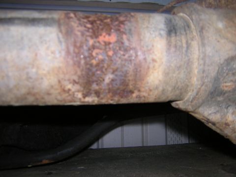 1979 Ford Bronco - This close-up shows significant rust and discoloration on a metal pipe, suggesting wear and tear.