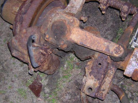 1979 Ford Bronco - This heavily rusted Dana 60 axle component, possibly from a 1979 Ford Bronco, shows significant corrosion and a detached black hose.