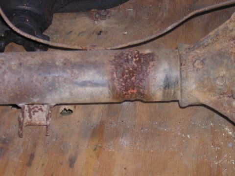 1979 Ford Bronco - Close-up of a heavily rusted axle housing, showing signs of wear and corrosion.