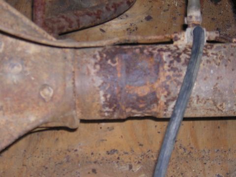 1979 Ford Bronco - Detail of a heavily rusted axle housing, likely from an older vehicle, showing significant corrosion.